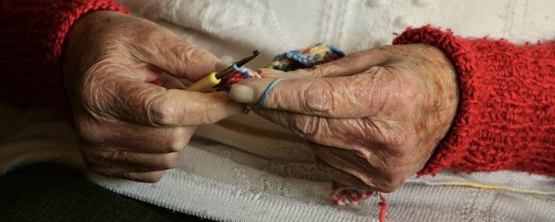 Elderly knitting in care home