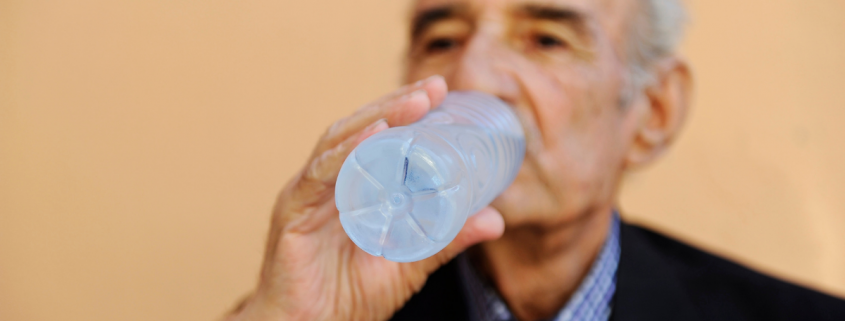 Senior drinking water flrom a bottle