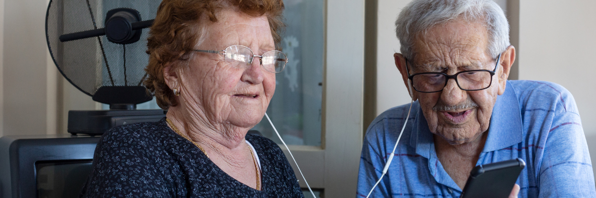 Older couple listening through earphones